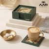Green coaster set with nature-themed design on a table with a cup of coffee and decorative bowl.